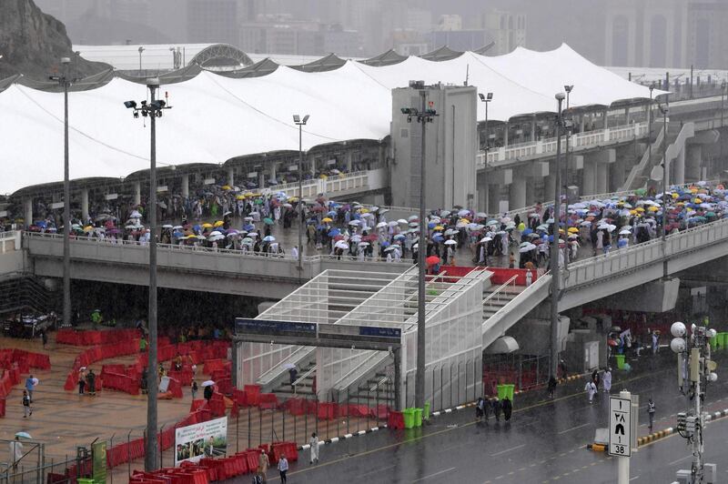 Muslim worshippers arrive in Mina under heavy rain to throw pebbles as part of the symbolic Jamrat Al Aqabah. AFP