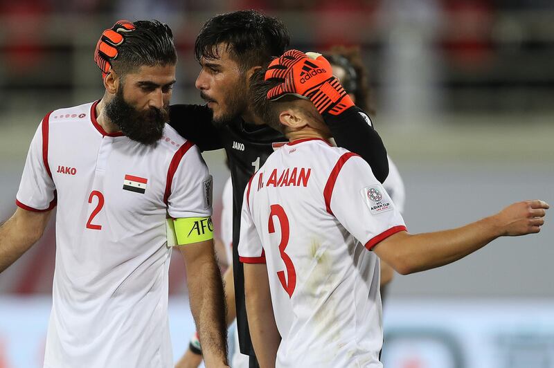 Ibrahim  Alma, centre, of Syria praises defenders Ahmad Al Saleh, left, and Mouaiad Al Ajaan. Getty Images