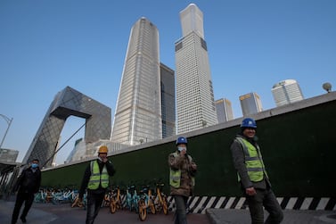 Migrant workers in in Beijing, China. The ILO said 8.8 per cent of global working hours were lost in 2020. EPA.