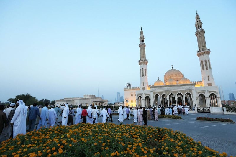 People arrive for the Eid Al Fitr morning prayer at Zabeel Mosque in Dubai. Pawan Singh / The National