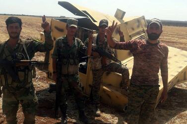 Syrian government soldiers pose in the Idlib countryside in a handout photograph released by the official Sana news agency on August 22, 2019. via Reuters