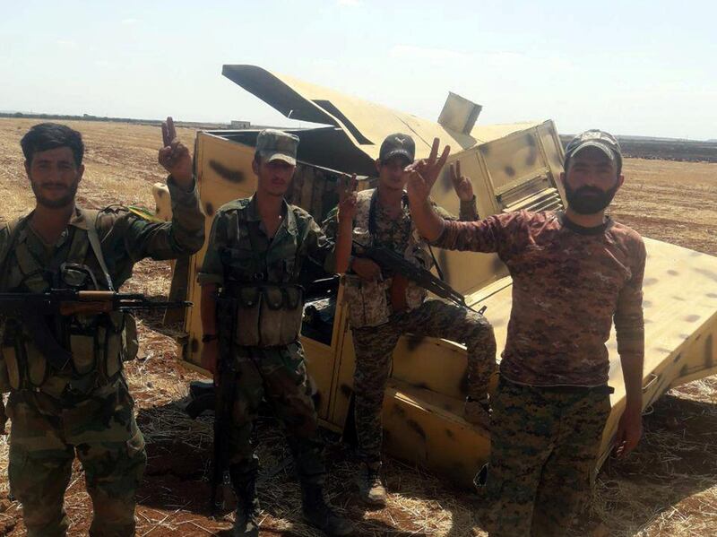 Syrian army soldiers gesture as they pose for a picture in Idlib countryside, Syria in this handout released by SANA on August 22, 2019. SANA/Handout via REUTERS ATTENTION EDITORS - THIS IMAGE WAS PROVIDED BY A THIRD PARTY. REUTERS IS UNABLE TO INDEPENDENTLY VERIFY THIS IMAGE.