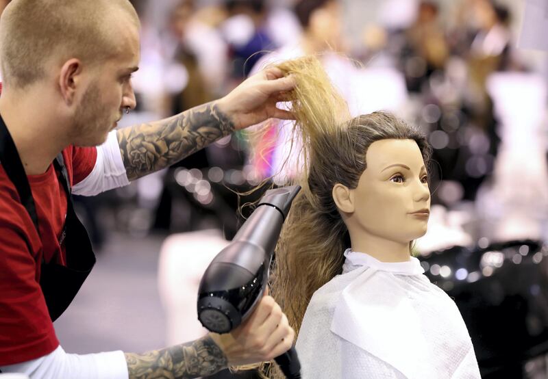 Abu Dhabi, United Arab Emirates - October 15th, 2017: People compete in the Hairdressing category at day 1 of World Skills 2017. Young people from 77 countries will come together and compete in 51 different skills competitions. Sunday, October 15th, 2017 at Abu Dhabi National Exhibition Center, Abu Dhabi. Chris Whiteoak / The National