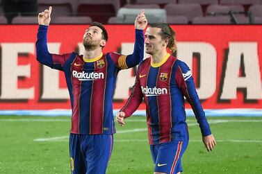 Barcelona's Argentinian forward Lionel Messi (L) celebrates with Barcelona's French midfielder Antoine Griezmann after scoring a goal during the Spanish league football match between FC Barcelona and Deportivo Alaves at the Camp Nou stadium in Barcelona on February 13, 2021. / AFP / LLUIS GENE