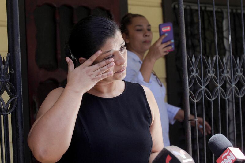 Karen Caballero, mother of half-siblings Fernando Jose Redondo and Alejandro Miguel Andino, reacts during an interview after learning that her sons had died in the back of the lorry. Reuters