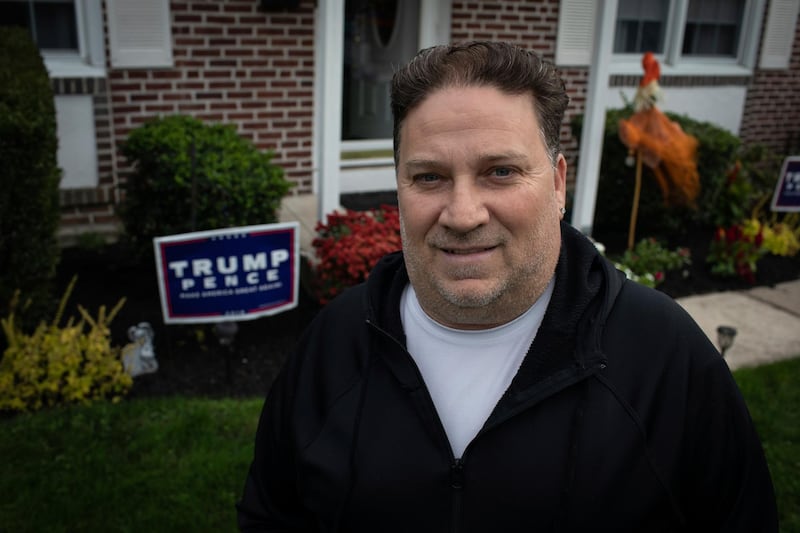 Scott Brady stands in front of his house with a Trump campaign sign in Springfield, Pa. Once a Democrat, Brady says he switched parties to vote for Donald Trump in 2016, and plans to vote for him again in 2020. AP Photo