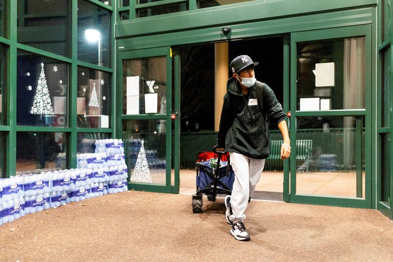 Volunteers bring in supplies to the YMCA of Northern Colorado. There were no reports of deaths or people missing early on December 31. Reuters