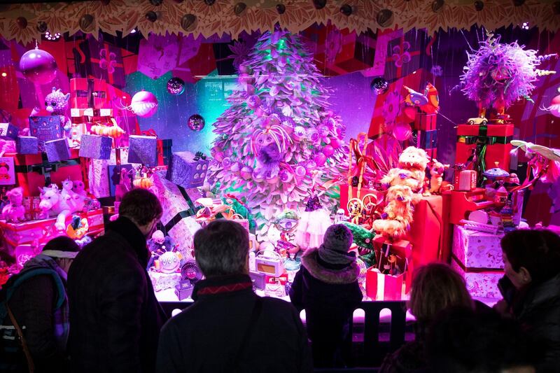 Passers-by, Christmas shoppers and tourists walk by and look at shop windows of the Galleries Lafayette in Paris, France. EPA