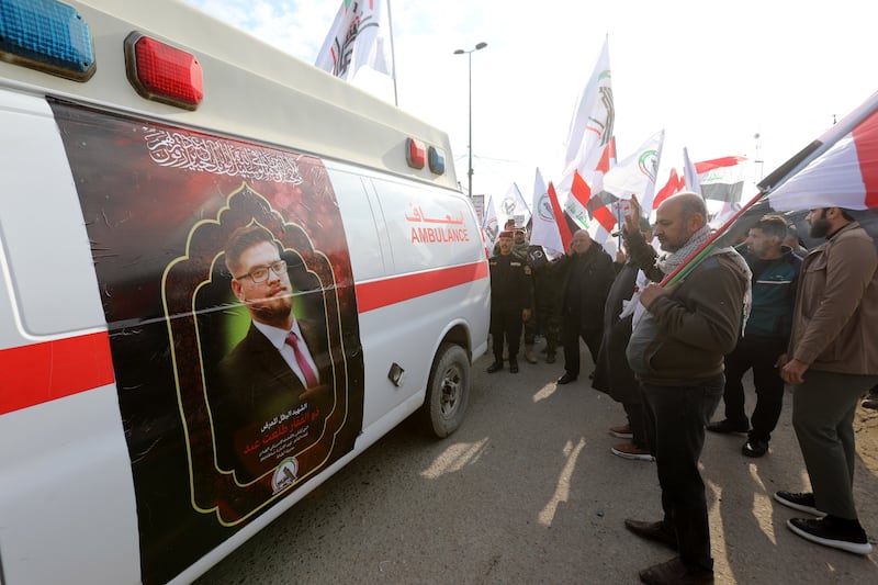 Members of Iraqi Shiite Popular Mobilization Forces (PMF) gather near an ambulance carrying the coffin of their comrade, who was killed in recent US air strikes in western Iraq, during a funeral procession in Baghdad, Iraq, 04 February 2024.  The United States Central Command (CENTCOM) said on 02 February it carried out airstrikes in Iraq and Syria on more than 85 targets against Iran's Islamic Revolutionary Guards Corps (IRGC) Quds Force and affiliated militia groups.  The US attacks were in retaliation for a drone strike that killed three US service members in Jordan the week before.  The Popular Mobilization Forces (PMF) announced that 16 of its members were killed and 36 others wounded in US air strikes that targeted eight locations in Al-Anbar Governorate, western Iraq, near the Iraqi-Syrian border.  The Iraqi government has condemned the retaliatory US strikes against pro-Iran militants on its territory as a violation of Iraqi sovereignty.   EPA / AHMED JALIL