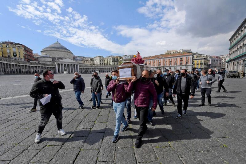 Taxi drivers stage a fake funeral for a taxi in a protest against the reduction of customers caused by restrictive measures aimed at stopping the spread of Covid-19 in the Campania Region in Naples, Italy. EPA
