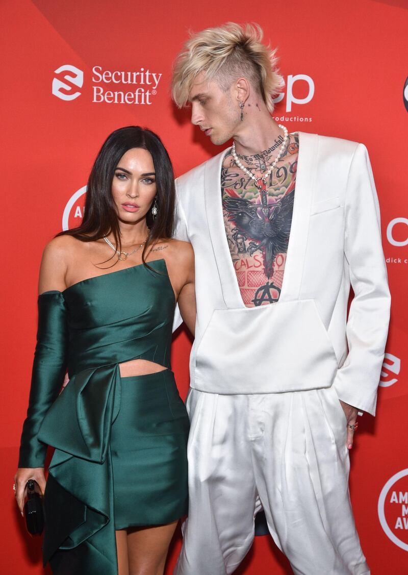 Machine Gun Kelly and Megan Fox arrive at the American Music Awards at the Microsoft Theatre on November 22, 2020 in Los Angeles. Fox wore an Azzi & Osta and Machine Gun Kelly wore Balmain. AFP