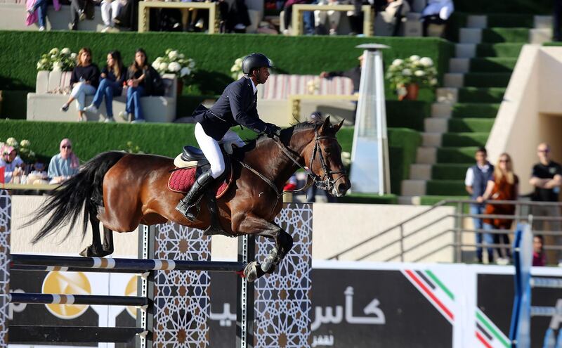 Mosaed al-Shuaibi rides a horse over a hurdle during the Emir's cup horse jumping competition in Kuwait City. AFP