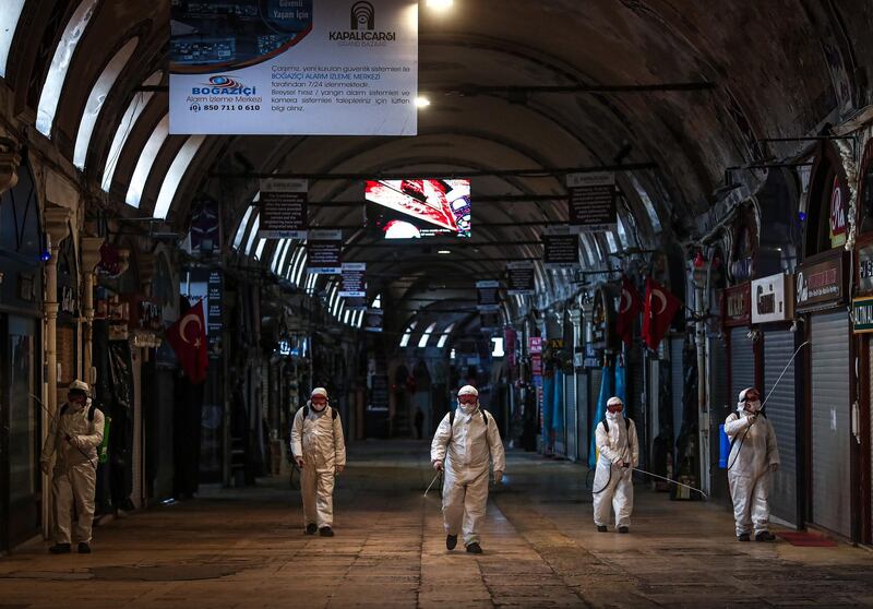 Employees disinfect streets and shops inside Istanbul's famous Grand Bazaar to prevent the spread of coronavirus.  EPA