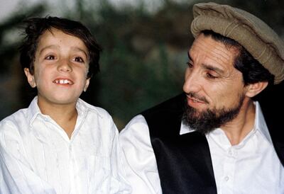 (FILES) In this file photo taken on August 21, 1997 Afghan Commander Ahmad Shah Massoud shares a private moment with his eight-year old son Ahmed, on August 21, 1997, in his house in the Panjshir Valley.  / AFP / Emmanuel DUNAND
