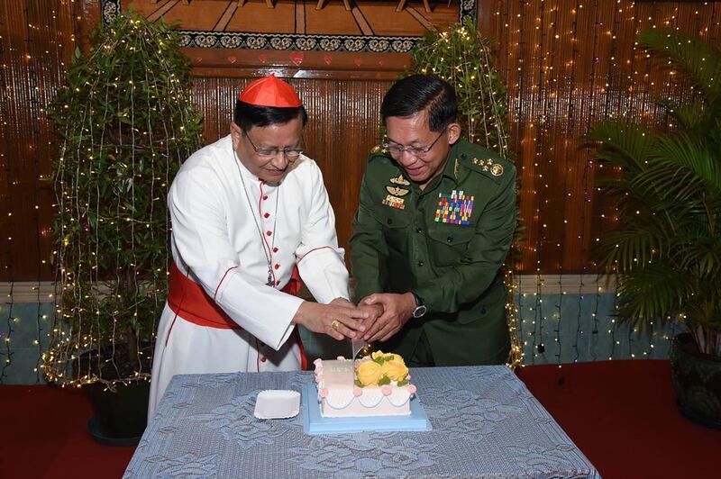 Cardinal Charles Bo, Mynamar's top Catholic official, cuts a Christmas cake with armed forces chief Senior General Min Aung Hlaing in Yangon. Myanmar Military Information Team / AFP