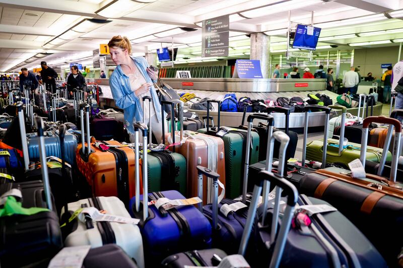 A traveller searches for a suitcase at a baggage holding area for Southwest Airlines at Denver International Airport in Colorado. AFP