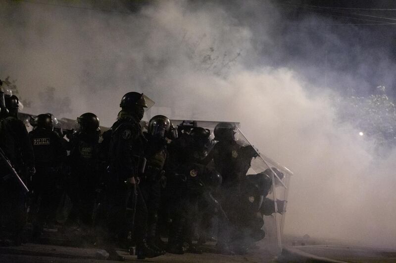 Police clash with demonstrators during a protest at Abancay avenue in Lima. Bloomberg