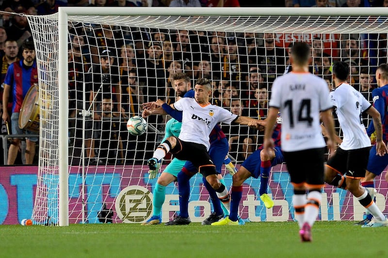 Valencia's Brazilian defender Gabriel Paulista vies with Barcelona's Spanish defender Gerard Pique in front of the goal. AFP