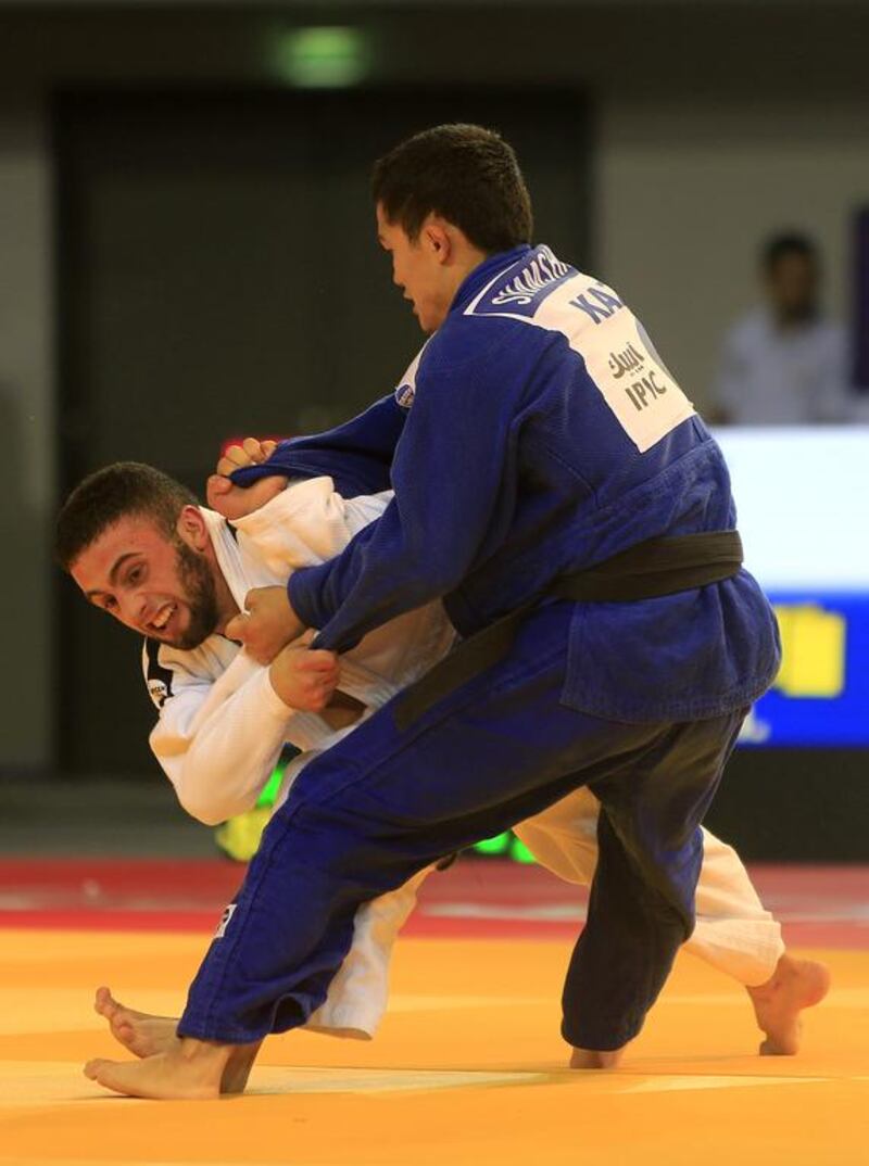 Magzhan Shamshadin, in blue from Kazakhstan, fights with Vahagn Hovsepyan from Armenia on the opening day of the International Judo Federation (IJF) Junior World Championships, which started at the Ipic Arena at the Zayed Sports City in Abu Dhabi on Friday. Ravindranath K / The National
