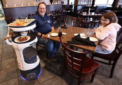 The Shanghai Bistro robot server named Jonny 5 delivers food and sings a surprise happy birthday song. AP