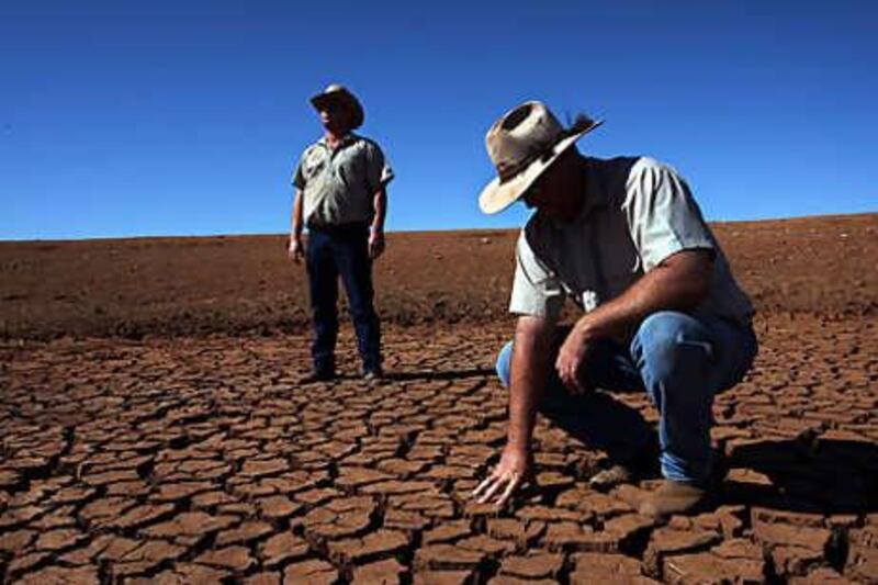 Two farmers survey the damage to their land after a drought struck their property in Parkes, New South Wales earlier in the year. Australia is the world's driest inhabited continent.