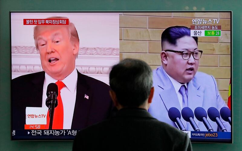 FILE - In this March 27, 2018 file photo, A man watches a TV screen showing file footages of U.S. President Donald Trump, left, and North Korean leader Kim Jong Un, right, during a news program at the Seoul Railway Station in Seoul, South Korea. Despite its feel-good emphasis on relationship-building, the first inter-Korean summit in more than a decade left a lot of question marks around the biggest and most contentious agenda item of them all: denuclearization. And that puts the ball squarely in the court of President Donald Trump, whose much anticipated sit-down with Kim is expected to be just weeks away. (AP Photo/Lee Jin-man, File)