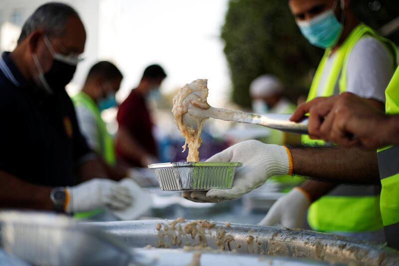 Volunteers from Adliya Charity prepare meals for distribution among the public during Ramadan, in Manama, Bahrain. Reuters