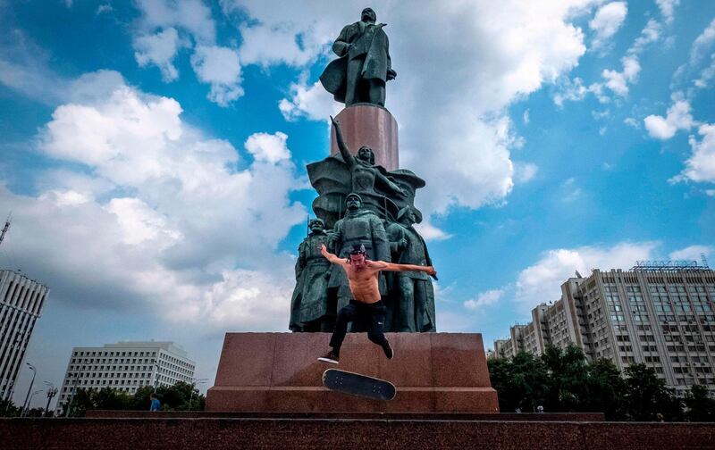 A skateboarder performs a trick in front of a monument to the Soviet Union founder Vladimir Lenin in Moscow. AFP