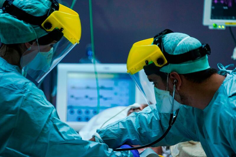 Medical workers wearing protective gears work, at the level intensive care unit for patients contaminated with coronavirus COVID-19 at Erasme Hospital in Brussels.   AFP