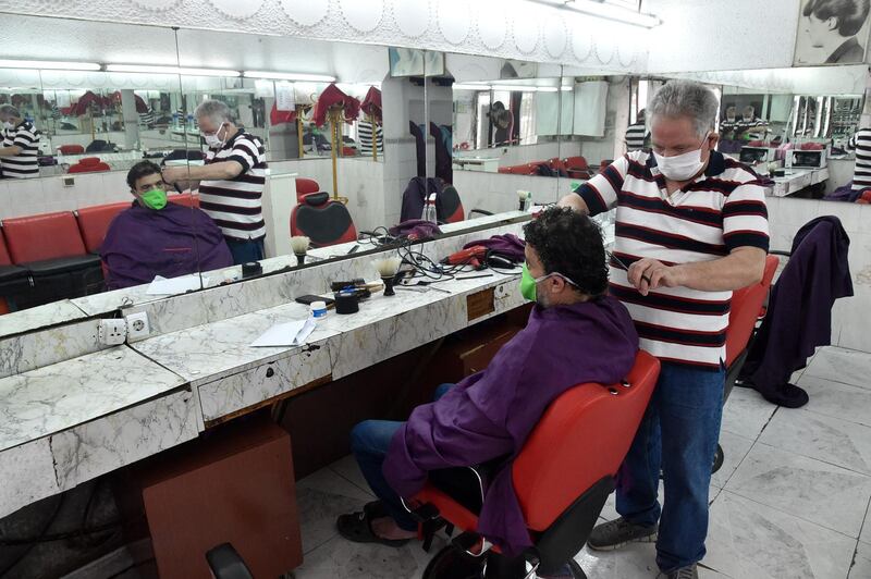 An Algerian gets a haircut in the capital Algiers after authorities eased some restrictions. AFP