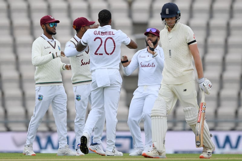 West Indies' Shannon Gabriel celebrates with teammates after  taking the wicket of England's Dom Sibley. AFP