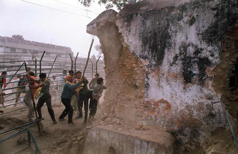Indian Hindu fundamentalists attack the wall of the 16th century Babri mosque with iron rods at a disputed holy site in the city of Ayodhya on December 6, 1992. Three senior members of India's ruling Hindu nationalist party including a government minister should face trial over the demolition of a mosque a quarter of a century ago, the supreme court ruled on April 19, 2017. Douglas Curran/AFP