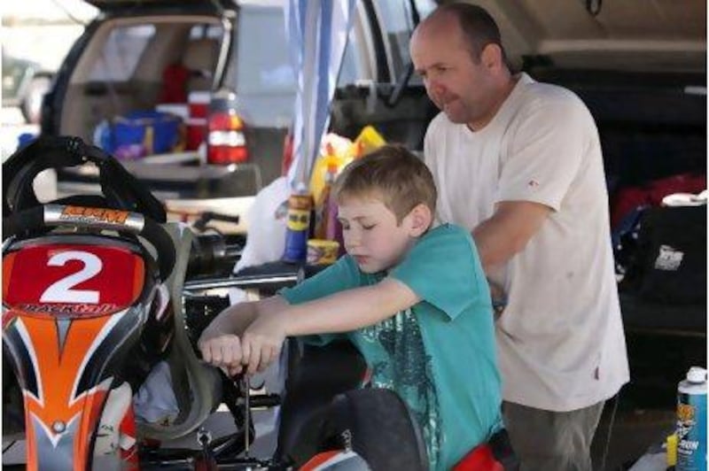 Paul Healy helps his son Finn prepare his kart. Paul has two more sons who want to take up karting.