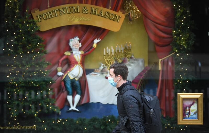 A man passes Christmas decorations in Picadilly in London. EPA