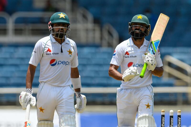Babar Azam (L) and Fawad Alam (R) of Pakistan walks off the field for the lunch break during day 1 of the 2nd Test between West Indies and Pakistan at Sabina Park, Kingston. AFP