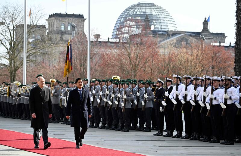 From left, German Chancellor Olaf Scholz and the President of the Philippines, Ferdinand Marcos, inspect a military guard during a ceremony in front of the Chancellery in Berlin. AFP