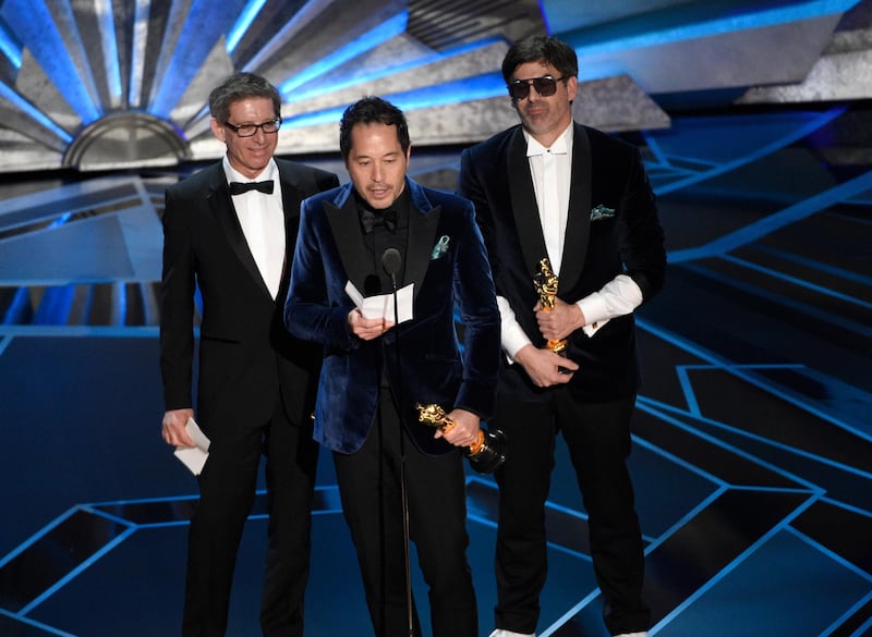 Jeffrey Melvin, from left, Paul Denham Austerberry, and Shane Vieau accept the award for best production design for "The Shape of Water" at the Oscars. Chris Pizzello / Invision / AP