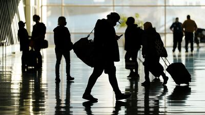 Passengers walk through Salt Lake City International Airport in Salt Lake City. AP Photo