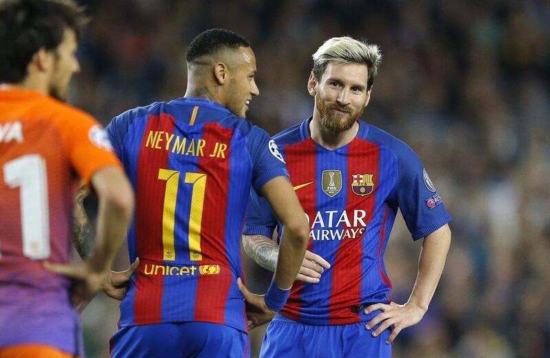 Barcelona’s Lionel Messi, right, smiles while talking with teammate Neymar. Francisco Seco / AP Photo