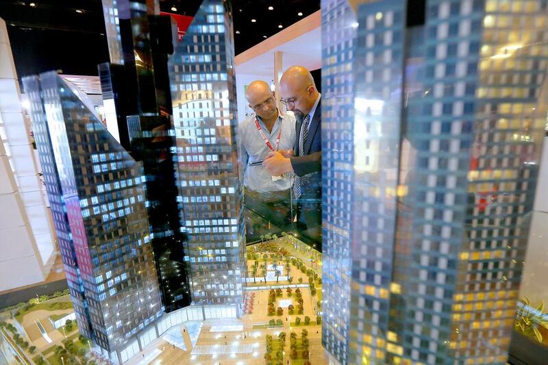 Visitors looking at Deyaar’s scale model of Central Park at DIFC during the Next Move property show. Pawan Singh / The National