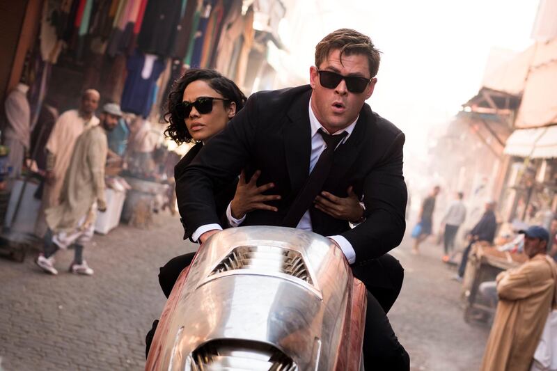 This image released by Sony Pictures shows Chris Hemsworth, foreground, and Tessa Thompson in a scene from Columbia Pictures' "Men in Black: International." (Giles Keyte/Sony/Columbia Pictures via AP)