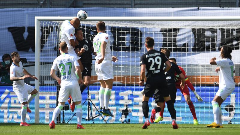 Wolfsburg defender John Brooks heads into his own net against Augsburg. The match finished 2-1 to Wolfsburg. AFP