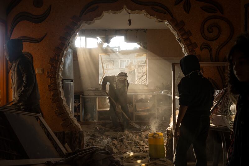 Palestinians look in their neighbour's damaged house after an Israeli strike in Rafah, in the south of Gaza. AP 