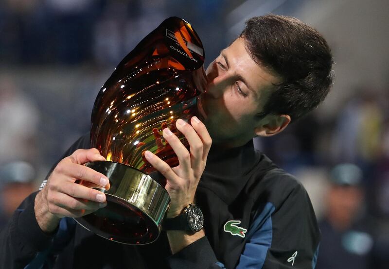 Novak Djokovic celebrates lifting the Mubadala World Tennis Championship trophy for the fourth time in his career. Djokovic beats Kevin Anderson, the defending champion, 6-4, 7-5, 7-5 in Abu Dhabi on Saturday night. Suhaib Salem / Reuters