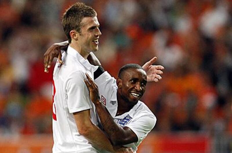 Jermain Defoe, right, celebrates with Michael Carrick after his brace earned England a 2-2 draw in