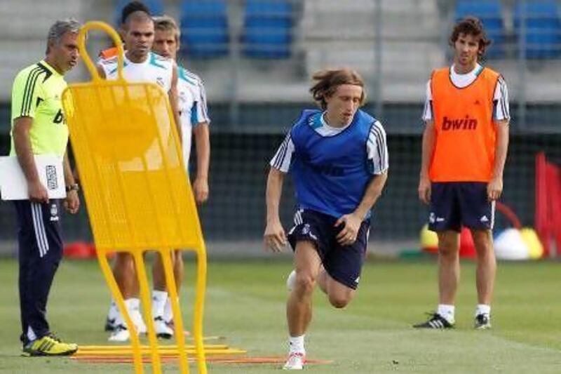 Luka Modric, centre, is watched by Real Madrid manager Jose Mourinho.