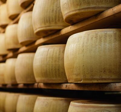 Rounds of parmesan cheese aging on racks in Modena, Emilia-Romagna, Italy. Getty Images