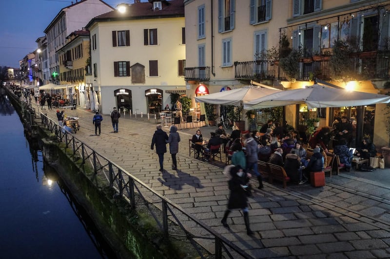 People enjoy the late afternoon as restaurants are opened in Milan. EPA