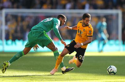 WOLVERHAMPTON, ENGLAND - OCTOBER 20:  Joao Moutinho of Wolverhampton Wanderers is fouled by Etienne Capoue of Watford  during the Premier League match between Wolverhampton Wanderers and Watford FC at Molineux on October 20, 2018 in Wolverhampton, United Kingdom.  (Photo by Richard Heathcote/Getty Images)