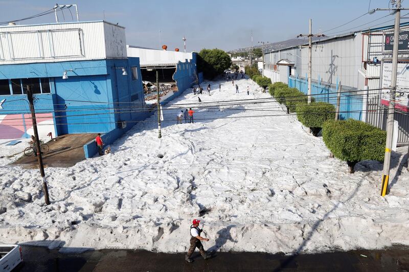 People walk as hail covers the streets in Guadalajara, Mexico. EPA